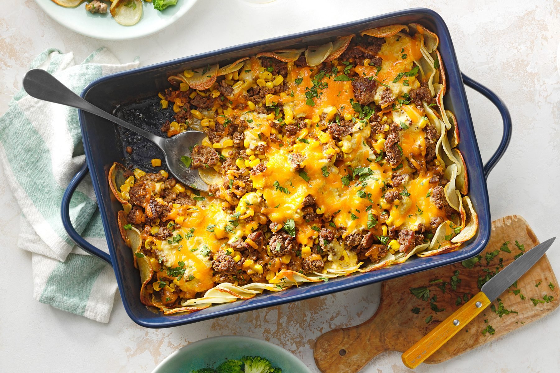 Hamburger Potato Casserole in baking tray with spoon top shot